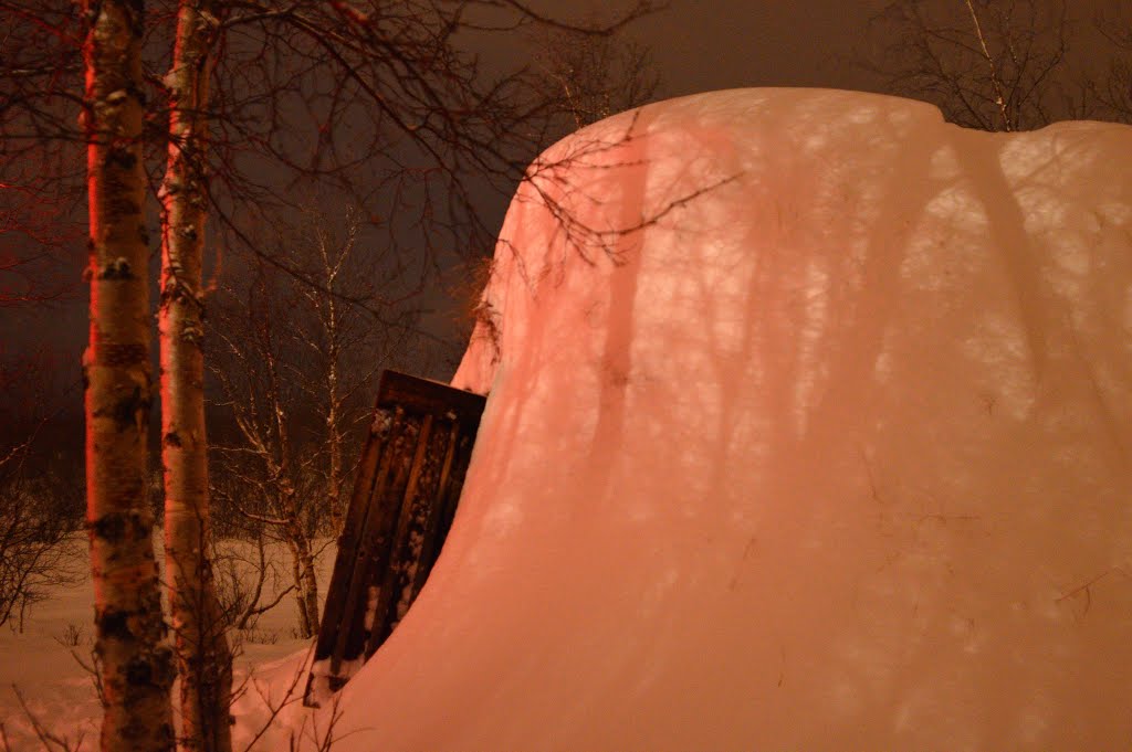 Sami Hut lit by headlamps in Abisko National Park by Shiree Schade