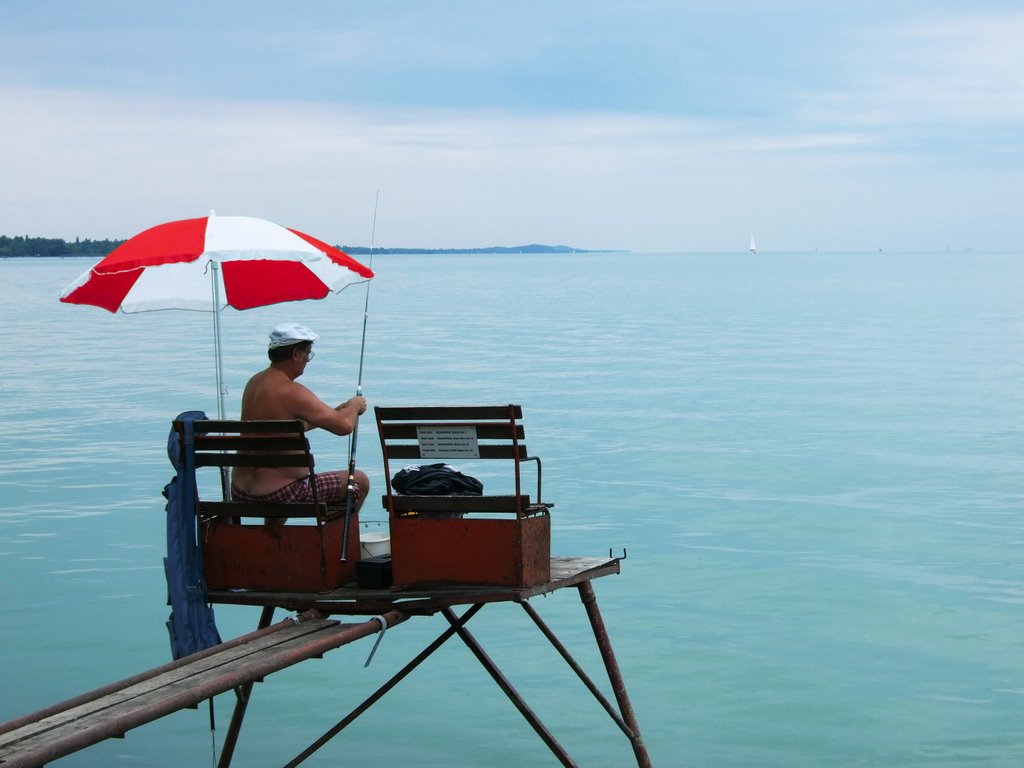 Angler on a platform, Balatonföldvar, Hungary by Marcus Herrmann