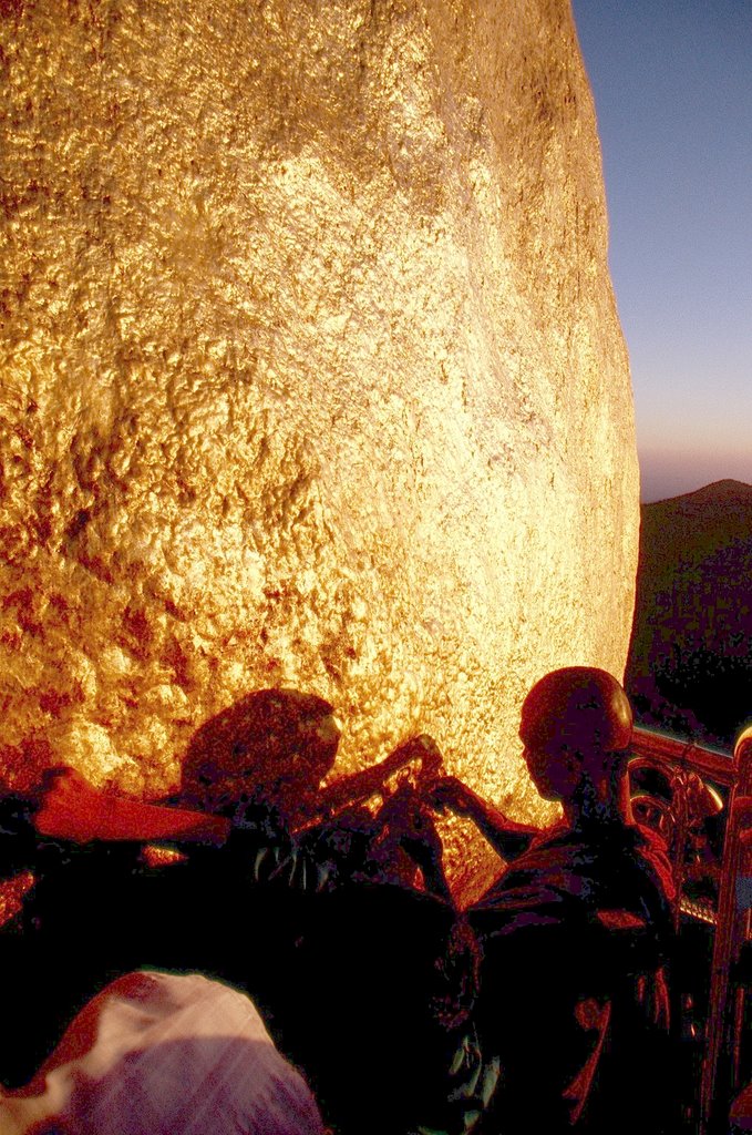 Pilgrims placing gold leafs on the Kyaiktyio stupa in Kyaikto, Burma. by Marcin Klocek (trave…