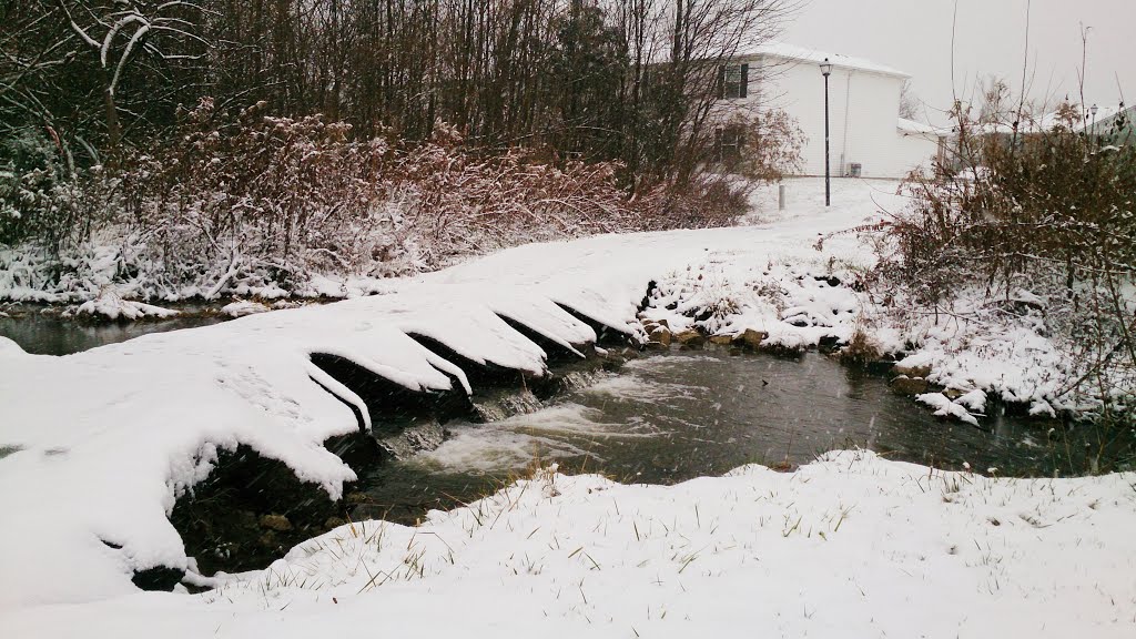 Flowing water under snowy bridge by abrahamabeach