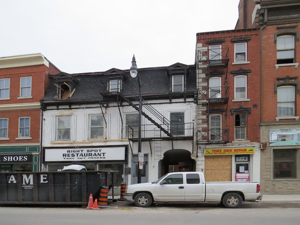 Canada's first Prime Minister, Sir John A. McDonald began his law practice in this building in 1835. He had practiced law for a year in Hallowell (Picton) in 1834 as an assistant. A developer wants to demolish this whole corner, but the City has refused a permit. It will remain, though there is some dispute about how much is original. Note the width of Tom's shoe repair on it's right. by Steve Manders