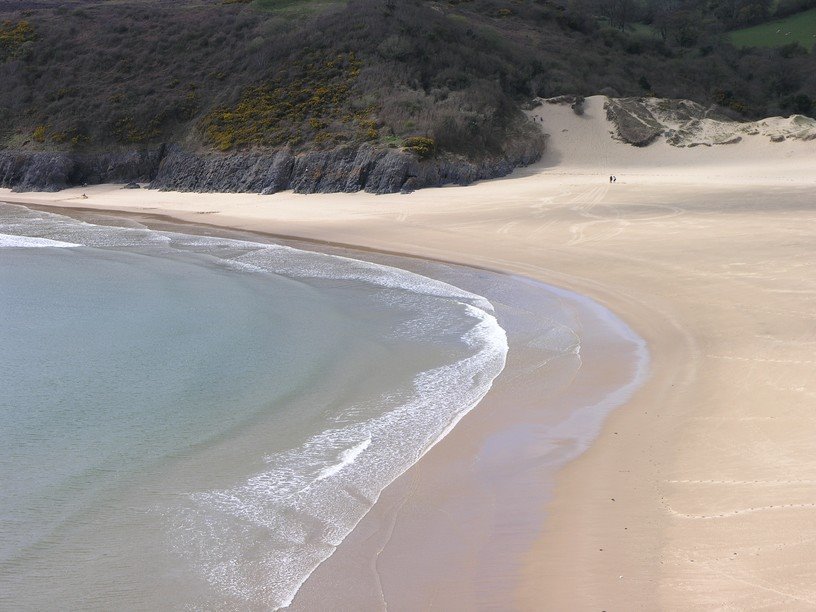 Gentle waves at Three Cliffs Bay by Jan Haas