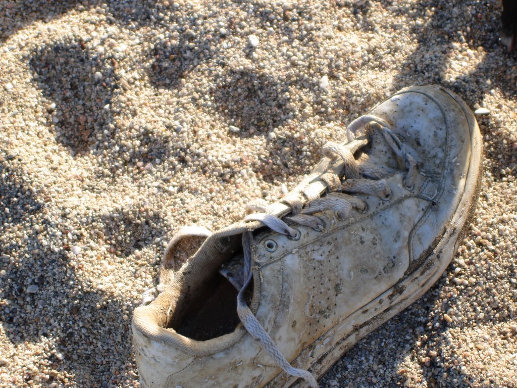 Forgotten shoe in the sand by brigittereynaert