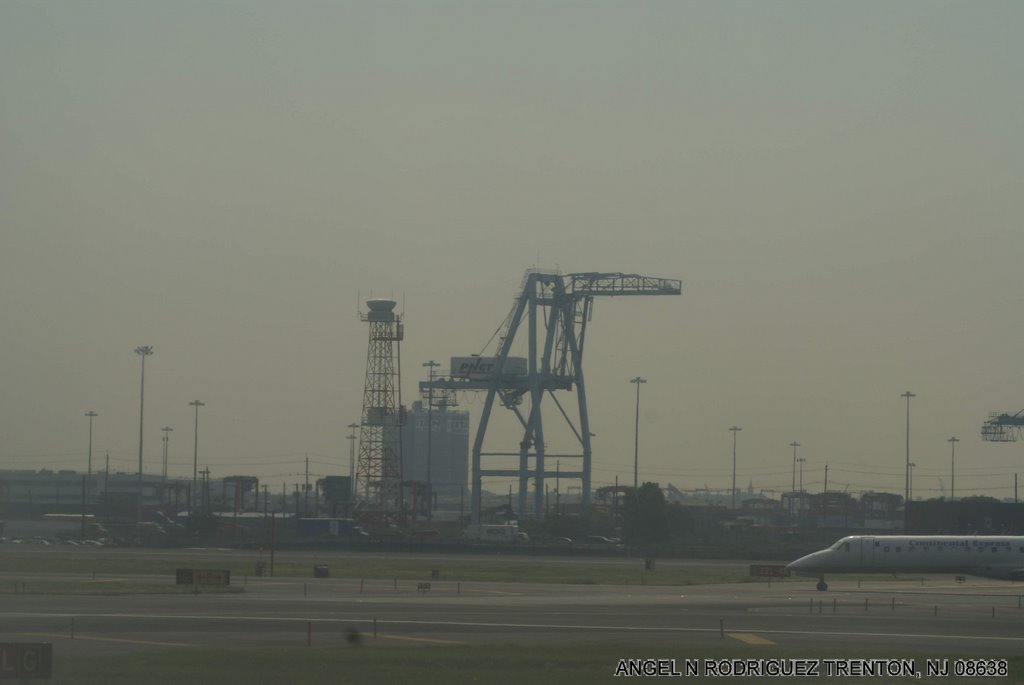 A CONTAINER LIFT AT NEWARK SEAPORT SEEN FROM AIRPORT by ANGEL N RODRIGUEZ