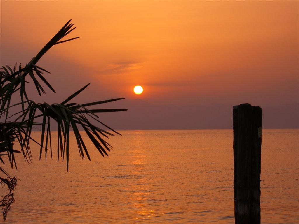 Sunset view from the promenade in Lazise by munkholm