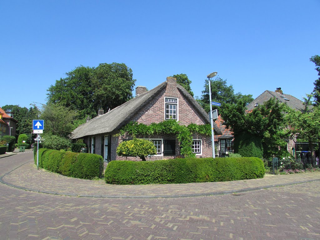 Old farm, but now in use as a house, in smalltown Laren. by Dick van Aggelen