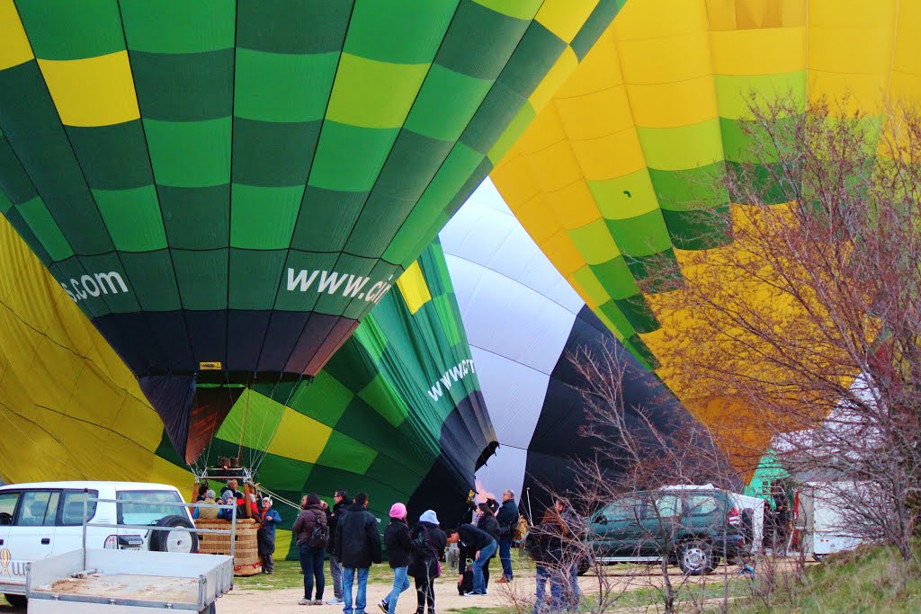 A parade of hot air balloons inflating in Segovia, Spain. by Red Meadows