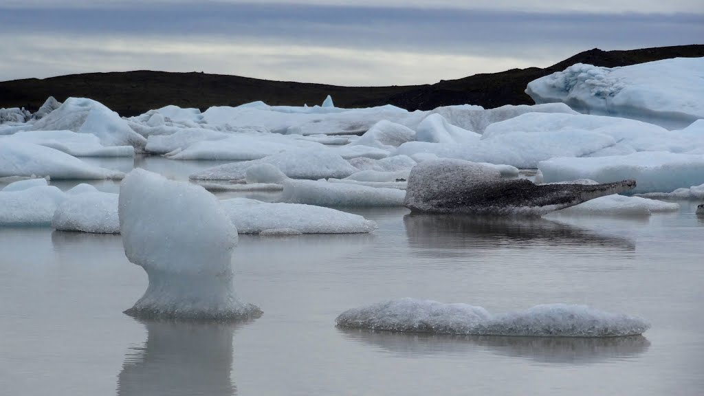 Glaciel lagoon with ice bergs, Fjallsjokull glacier, Iceland by John Eby