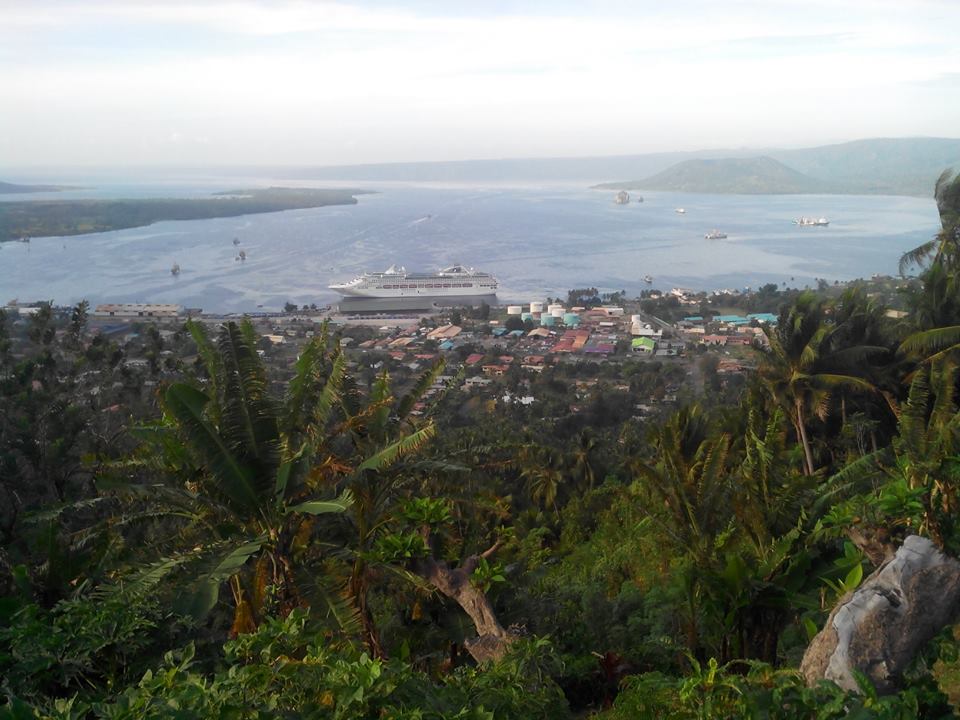 Dawn Princess Tourist Ship Berthing at the RABAUK Wharf in Simpson Harbour, with the BeeHive Rocks and VULCAN Volcano seen in background on rightside, in East New Britain in PNG, Photo by John B. Dikaung on 2-07-2015 by Peter John Tate