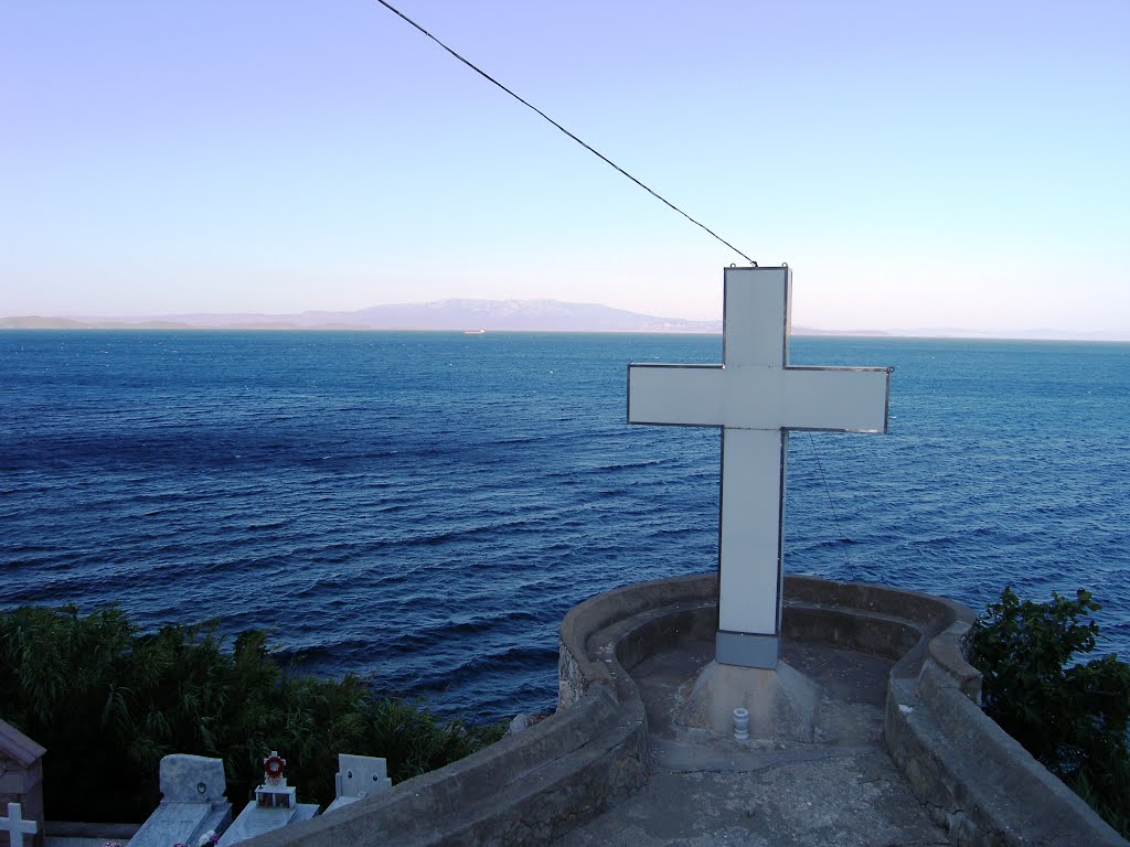 The Cross overlooking at the sea at Panayia Mirsinidiotisa Monastery by Archimedes Nikolakis