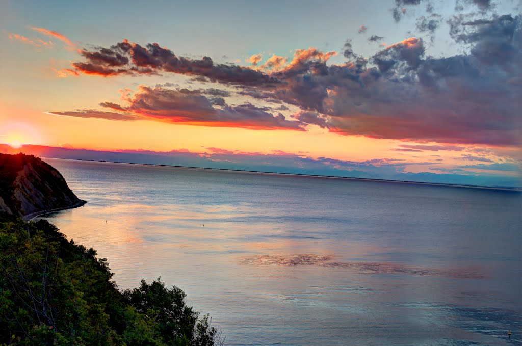 Sun sets behind Italy across the sea by rlubej