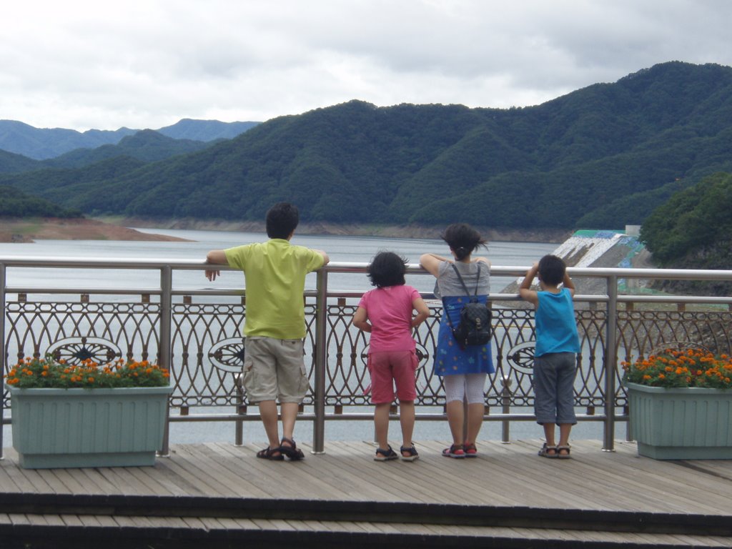 A family in front of dam in Soyanggang by stephan Seo