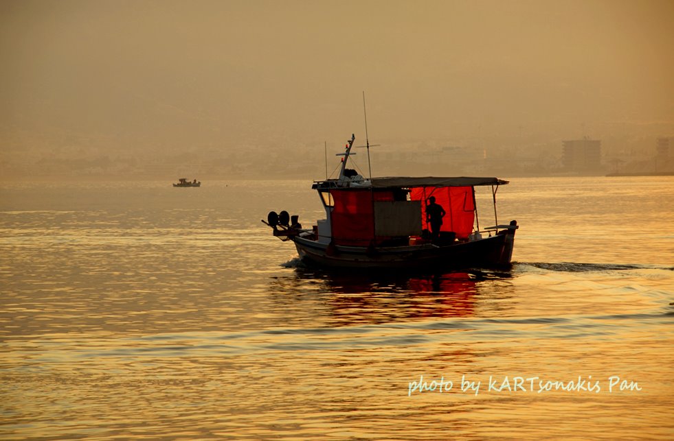 Fishing boat daybreak outside the port of Corinth Greece Hellas. Ψαρόβαρκα ξημέρωμα έξω από το Λιμάνι της Κορίνθου Ελλάδα. by kartson