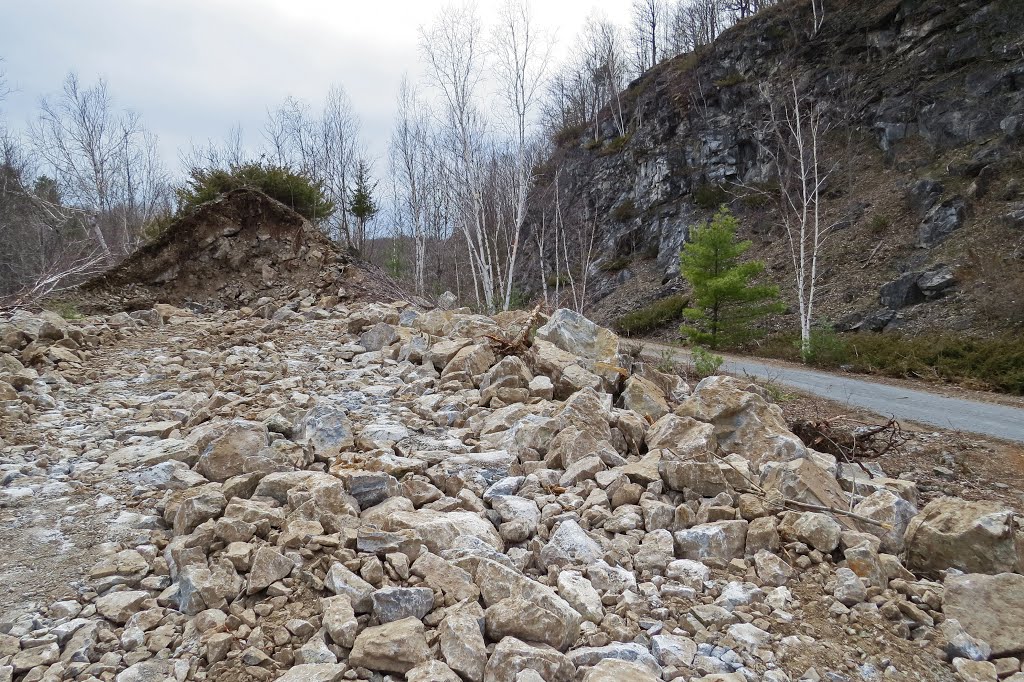 Crystalline marble rock from one of the largest landslides in southern Ontario that occured on the right side of the trail about 1914 is exposed as some is used for repair work to the Cataraqui Trail, by the Cataraqui Region Conservation Authority. The CNoR rainway and trail are built along an ancient 10 km. long fault line with uplifted granite on the west side. by Steve Manders