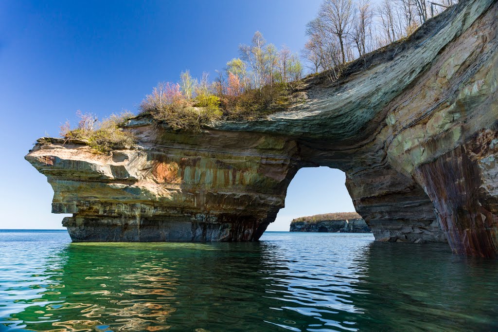 Pictured Rocks National Lakeshore is a U.S. National Lakeshore on the shore of Lake Superior in the Upper Peninsula of Michigan, United States. It extends for 42 miles (67 km) along the shore and covers 73,236 acres (114 sq mi; 296 km2). The park offers sp by Tudor ApMadoc