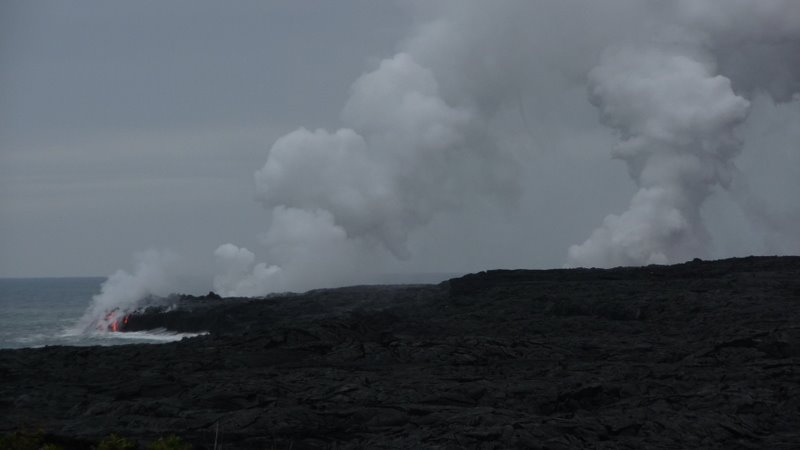 Lava, steam, and a small vortex in the steam by Andy Goss