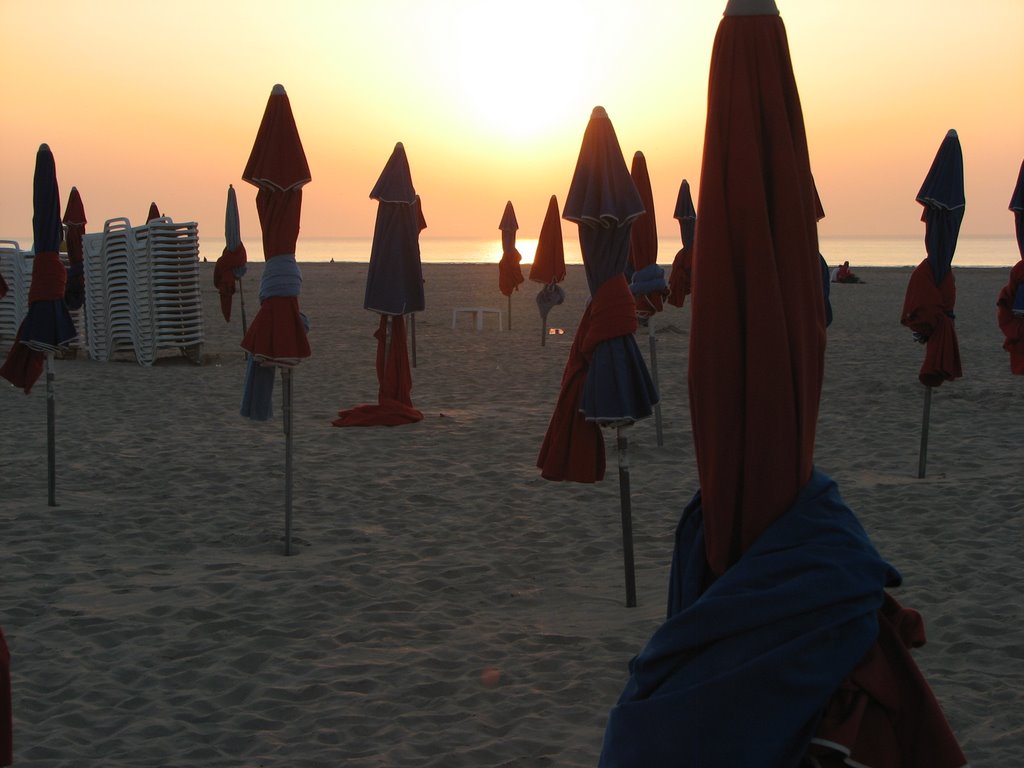 Deauville beach umbrellas at sunset by mycroft