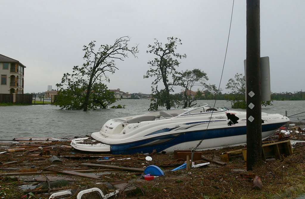 A damaged boat sitting next to the Red Bluff bridge on Taylor Lake by jiangliu