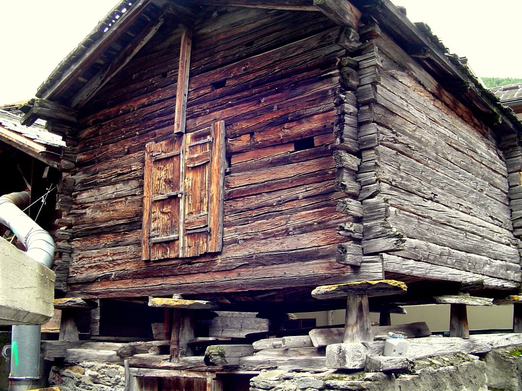 Saas Grund, Shed for Meatdrying. The flat round stones, protecting against mouses. No rats in this area by Jan Hoppe