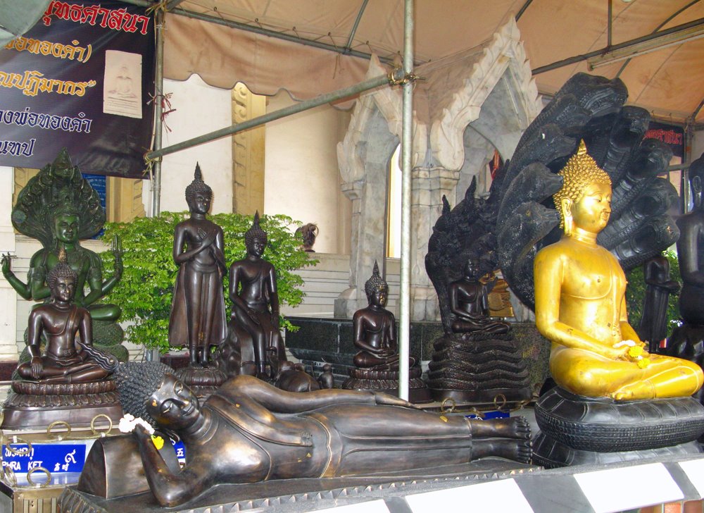 Bangkok, Thailand. Buddahs outside Wat Trimitr. by Eivind Friedricksen