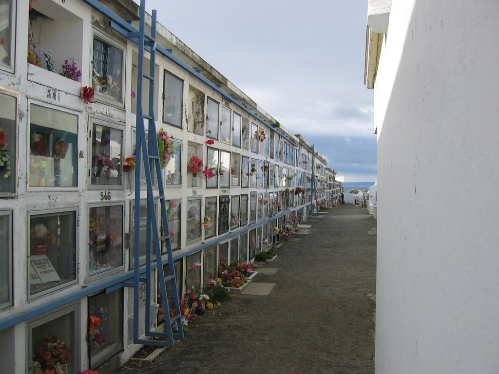 Graves stacked with ladder for access. Each has pictures and other momentos behind a glass front. by jwsmith3