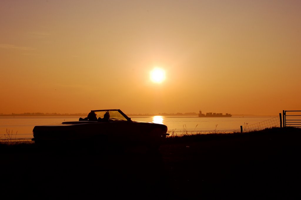 Looking at the sun going down at Waarde, Netherlands by © Andre Speek