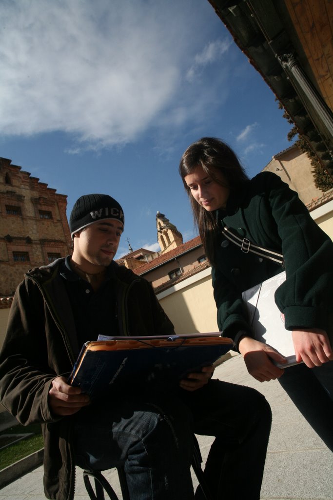 Students looking over an assignment near the cafeteria at IE University. by ieontheweb