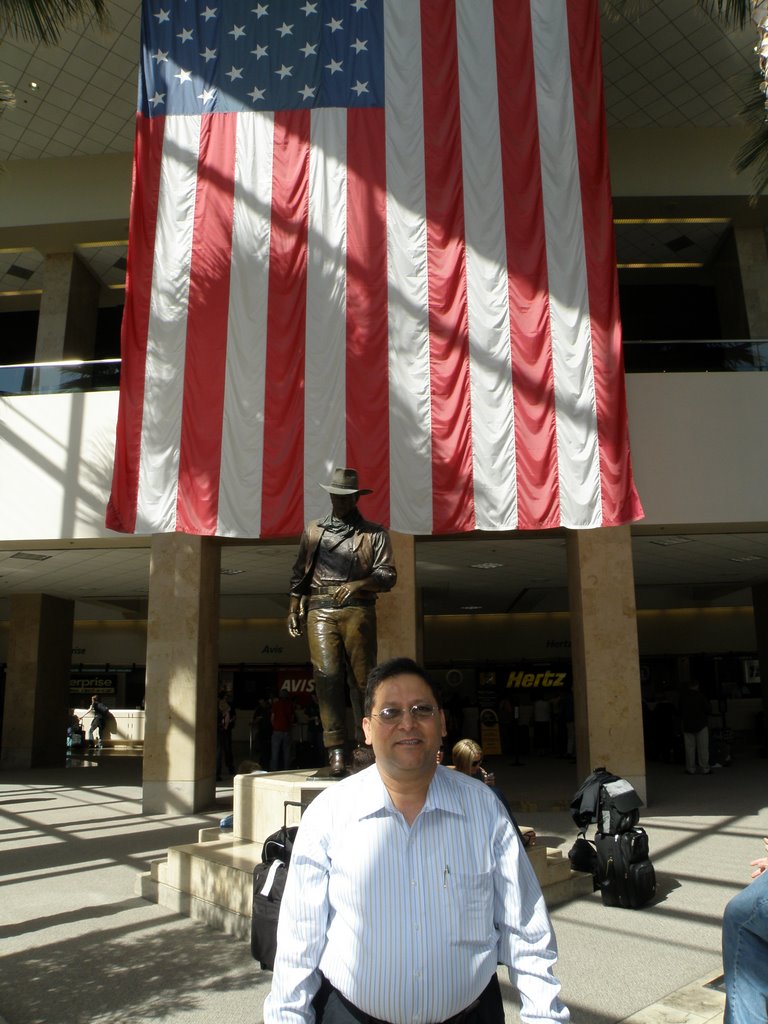 Mr. Nasir Uddin Standing In Front Of The Statue Of John Wayne At John Wayne Airport,Orange County,CA. by Nasir Uddin