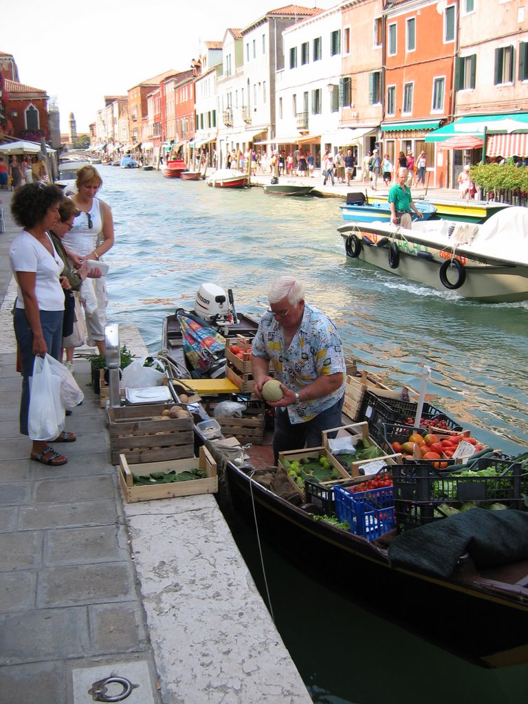 Murano - grocer man on the water by John A Forbes