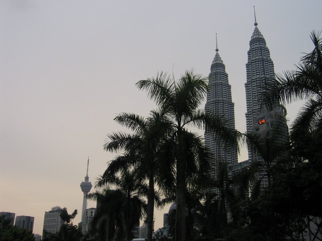 Kuala Lumpur - Petronas Towers under palm trees by Antoine GUILBOT