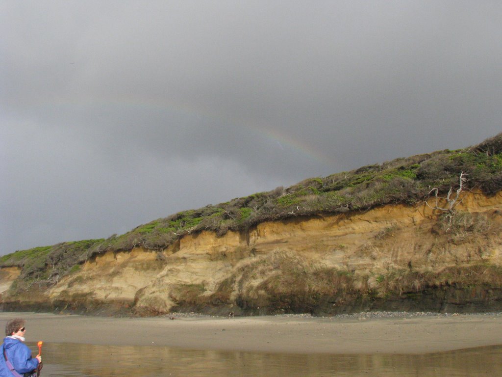 Rainbow over the beach by greggster7