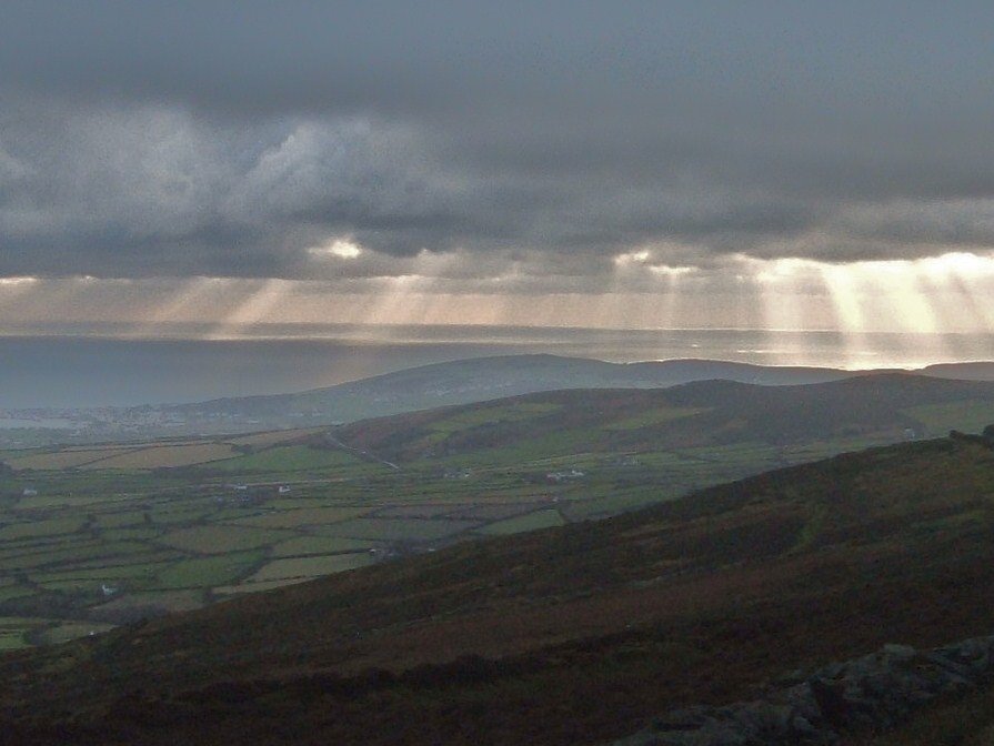 Sunbeams over the south of the island. by Tony Archibald