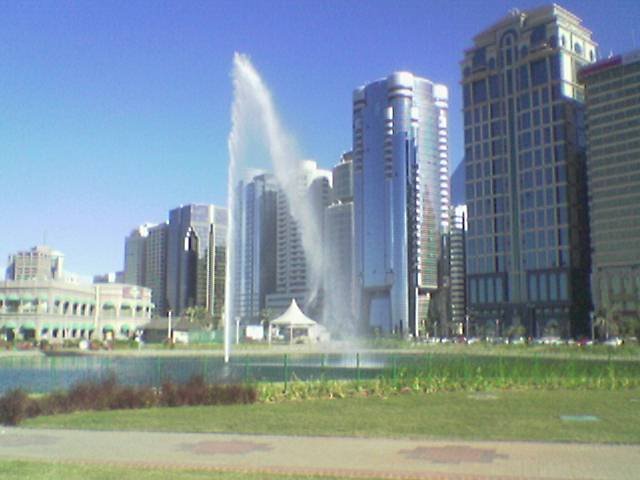 Abu Dhabi Corniche - Fountain and Buildings by Shrung Vachhrajani