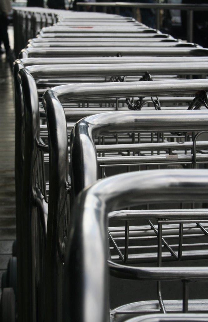 Luggage cars waiting at Barcelona Airport by Artheos