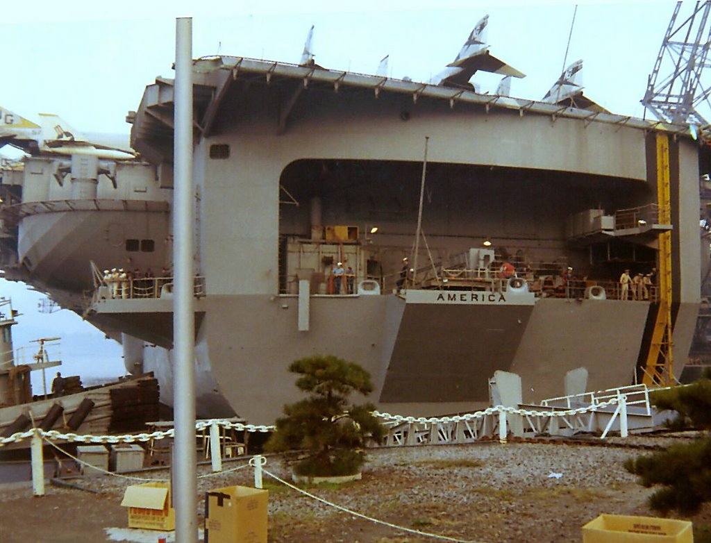 The Aircraft Carrier America in port in Yokosuka Japan - 1970 by Dennis Sosnowski