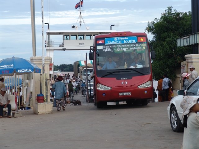 Vehicles ascend from ferry at Neak Leung by ckim