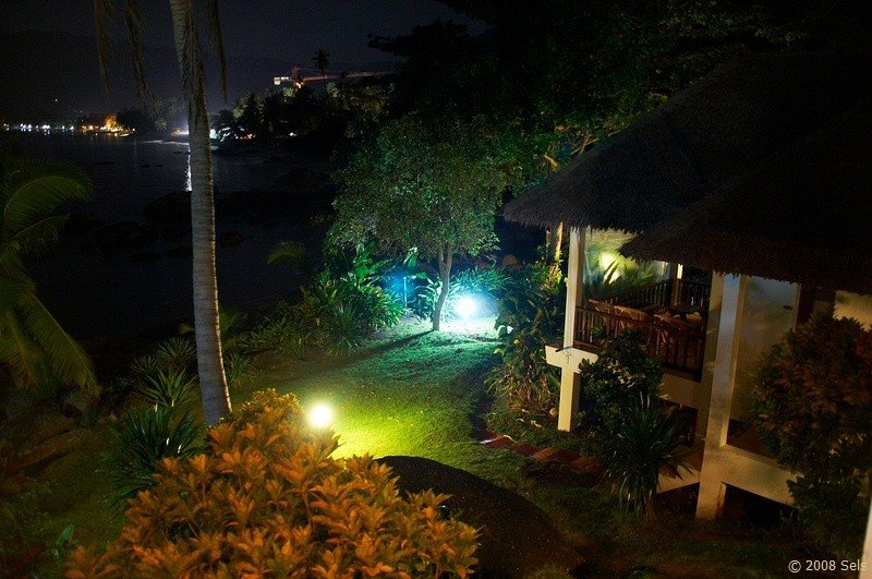 Bay view resort at night. Beachfront bungalows. by hippotravel