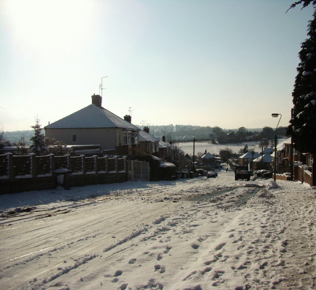 Looking down a snowy Richmond Hill Road into a low winter sun, Sheffield S13 by sixxsix