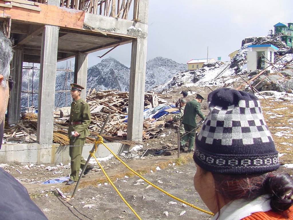 Chinese soldiers on other side of a thin barbed wire. Chinese government was constructing a huge building during October 2008 on the ridge overlooking india and china, Nathula, Sikkim by kundan singh pangtey