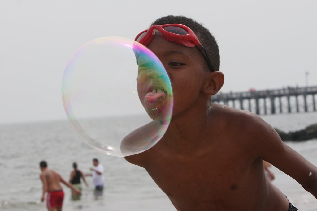 BOY AND THE BUBBLE IN CONEY ISLAND BEACH BKLYN NY USA by SANTIAGO A.BAEZ