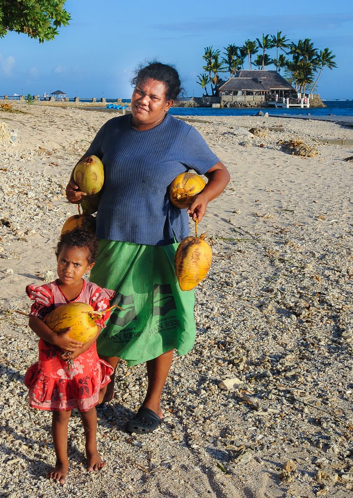 Woman and child carrying coconuts by hzeller