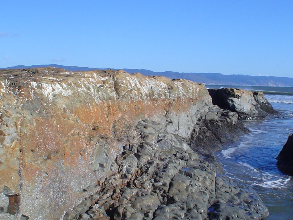 Rounded bedrock along beach by nmnc