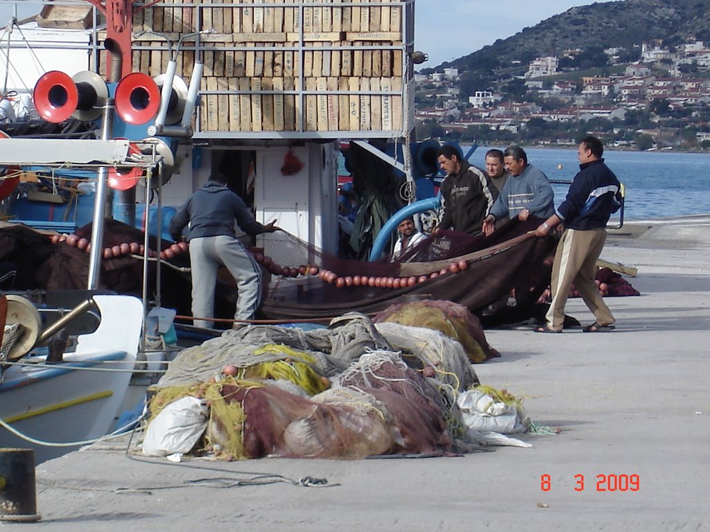 Preparing the fishing nets, Salamina island, Greece by george moutsakis