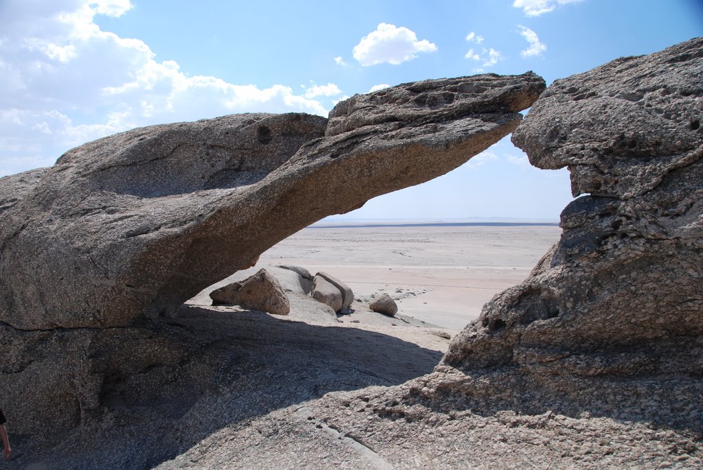 Rock window on desert by Andrew Faeh