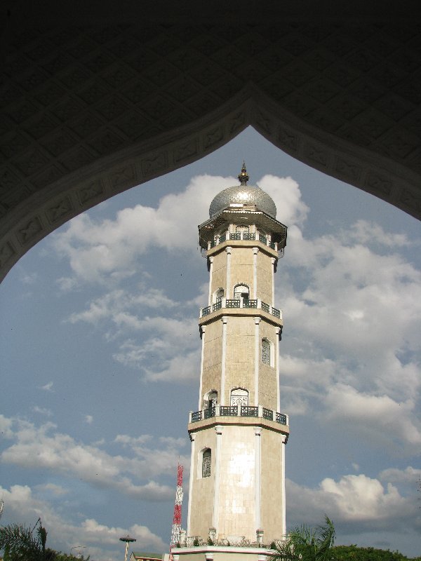 TOWER FRAMED BY MOSQUE by T. Palgunadi