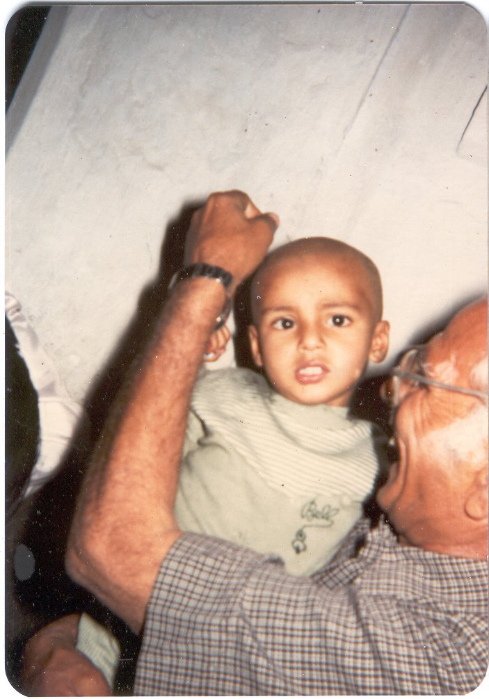 Indian Hindu Rite, Mundan Sanskar, Vaibhav in 1985 at Shitla Mata Mandir, Doonga Hanuman, Guru Bazar, Amritsar with grandfather by Parbodh C Bali