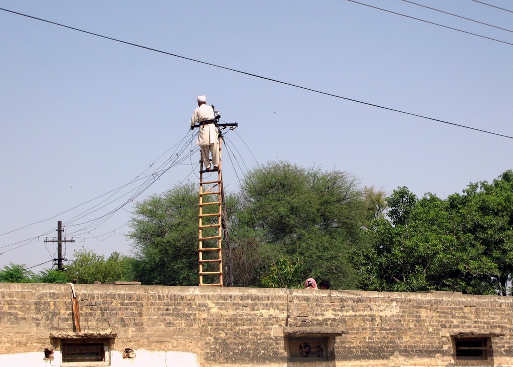 Shalimar Link Road Man Working on Eledtric Wire by Waheed Ashraf