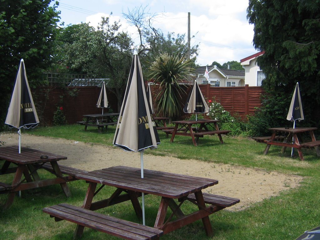 The red lion little garden, filled with wooden tables and parasols by Robert'sGoogleEarthPictures