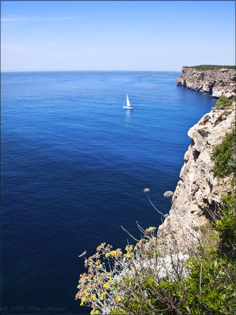 Small ship on a big sea. Cala'n Porter, Menorca, Spain by Wim Janssen