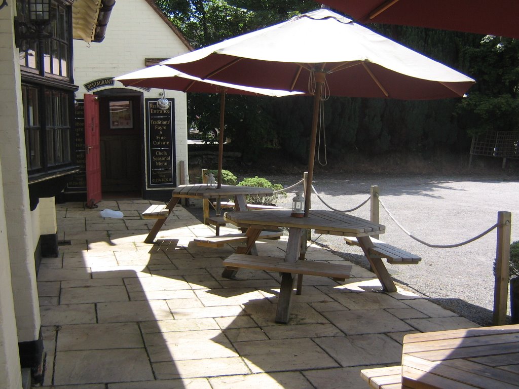 The set of few wooden tables and parasols, outside the Poacher by Robert'sGoogleEarthPictures